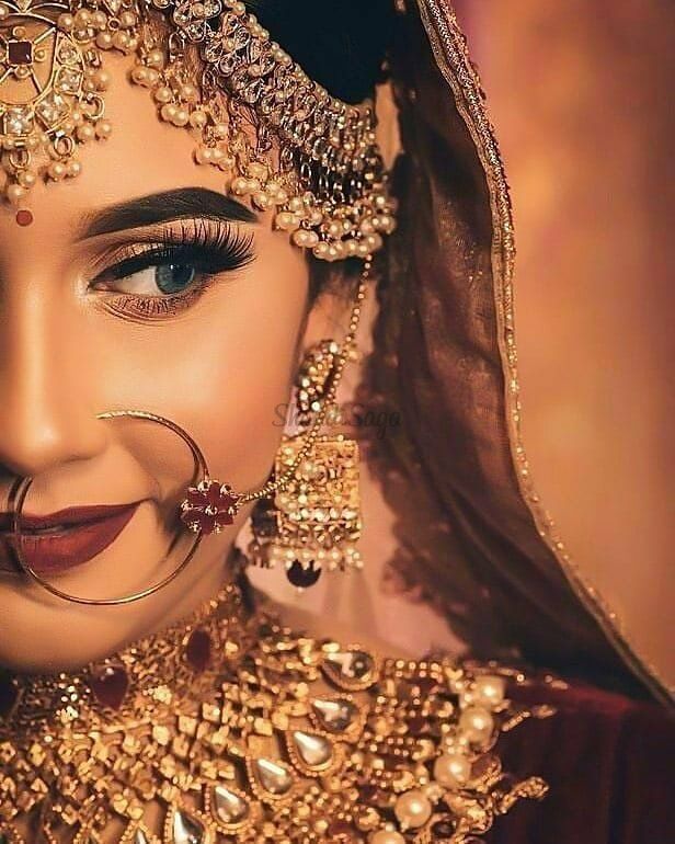 a woman with makeup and jewelry on her face