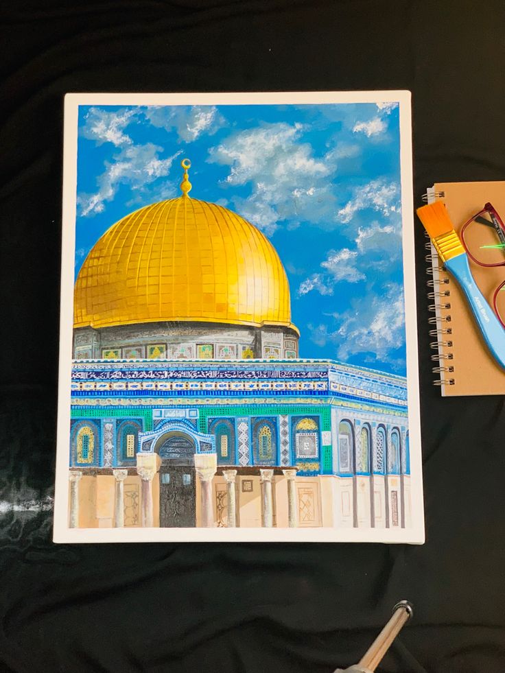 a drawing of the dome of the rock on top of a table next to a pair of scissors