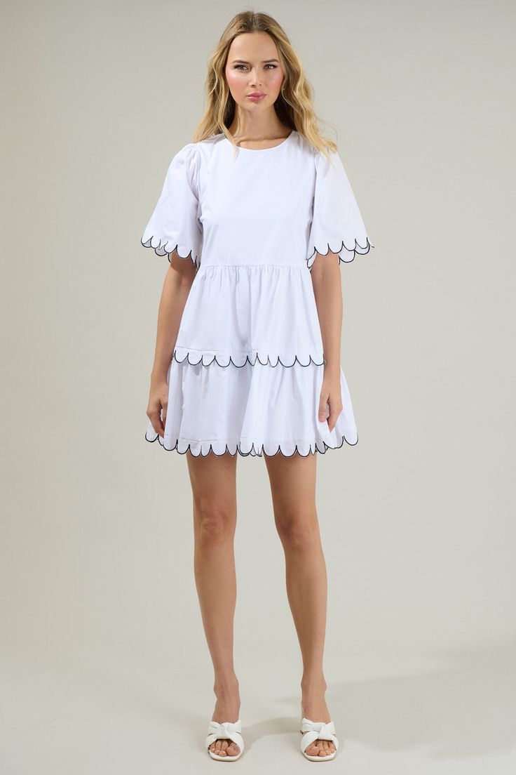 Head anywhere looking oh-so-cute in the Quintana Tiered Mini Dress! We just love the tiers and short sleeves on this dress with a cute design all over the borders. It has a flowy fit and a keyhole in the back; making it easier to get in and out of. Wear this with shoes for a more casual look or style it up with heels! - Scalloped Mini dress- Flutter sleeves- Keyhole- Breathable - Comes in 2 colorsSize + Fit - Model is 5'8" and wearing size XS- Measurements taken from size S - Chest: 19 1/4"- Len White Ruffle Hem Mini Dress, Short Sleeve Tiered Dress With Ruffle Hem For Beach, Short Sleeve Tiered Ruffle Dress For Beach, White Mini Hem Dress With Ruffles, Summer Tiered Dress With Ruffles And Short Sleeves, Summer Tiered Short Sleeve Dress With Ruffle Hem, Summer Tiered Dress With Ruffle Hem And Short Sleeves, Summer Dresses With Scalloped Edges And Short Sleeves, White Tiered Ruffle Dress For Summer