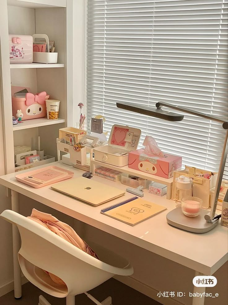 a white desk topped with lots of items next to a window