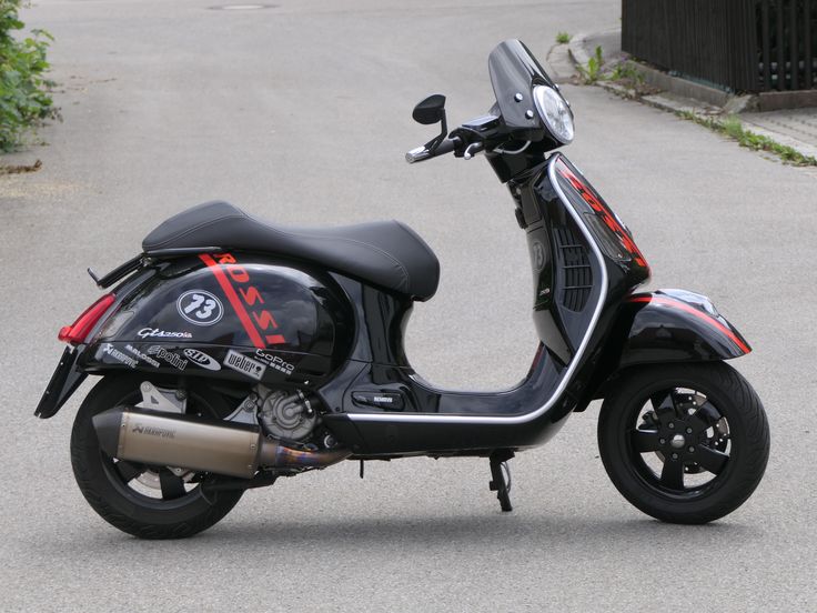 a motor scooter parked on the side of a road