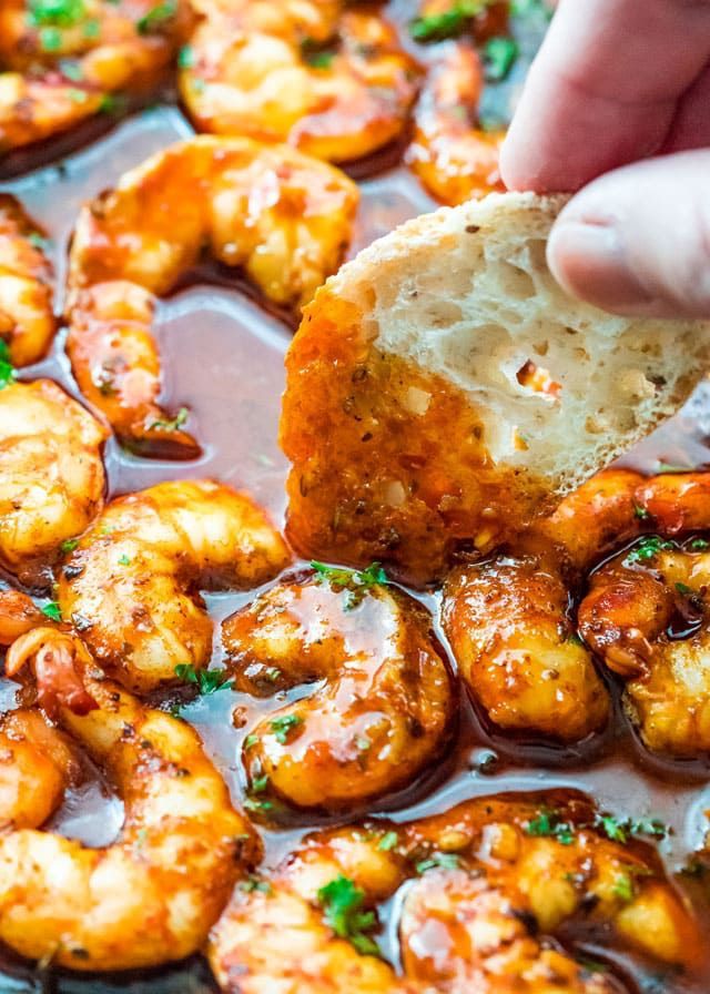 someone is dipping some bread into the shrimp