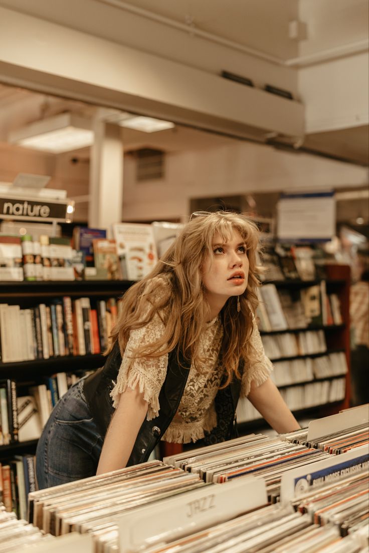 Blond Girl in a record store wearing leather vest and sunglasses 1970s vibes Vintage Senior Pictures, Creative Senior Pictures, Senior Photoshoot Poses, Unique Senior Pictures, Senior Photo Poses, Vintage Photoshoot, Photographie Portrait Inspiration, Photoshoot Idea, Grad Pics