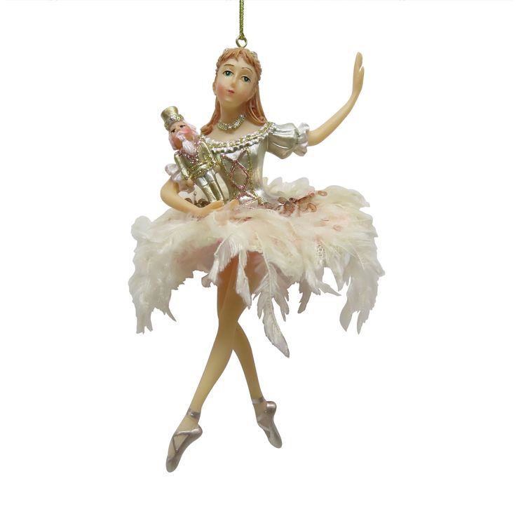 a christmas ornament with a ballerina holding a bottle