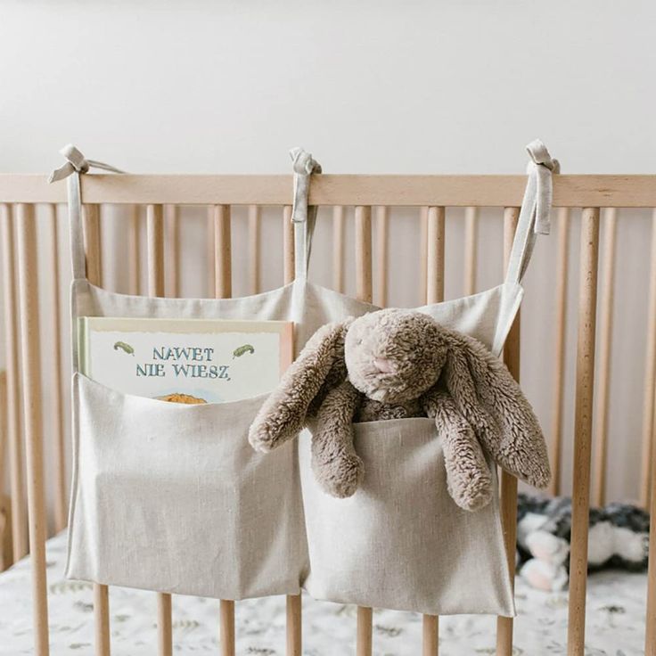 a stuffed animal sitting inside of a crib