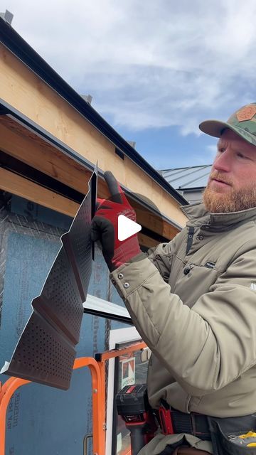 a man is working on the side of a building with a roof shinning tool