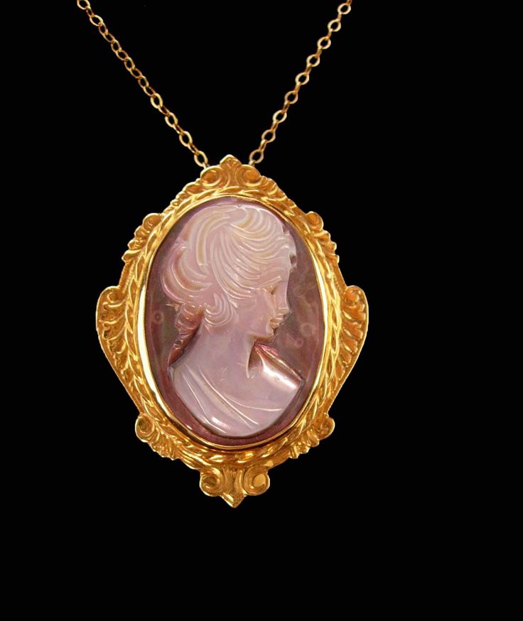 The nice thing about this is that you can wear it as a brooch or a necklace, It has a bale which stays hidden when worn as a brooch. Solid 14k Gold with an abalone carved cameo it is full of quality. It has a signature or initial I can't make out. The quality chain is Gold over sterling  and it has many hallmarks on it as well.  Beautiful details are on this young woman's face. The setting is in yellow gold. A beautiful gift for a new mother or the cameo lover.  7-3-21ebbothsite Evening Brooch Pendant Necklaces, Pendant Necklaces With Brooch For Evening, Antique Formal Necklace With Brooch, Antique Formal Necklaces With Brooch, Antique Style Necklaces For Anniversary, Antique Necklace With Brooch For Formal Occasions, Elegant Medallion Brooch For Formal Occasions, Elegant Large Pendant Brooches For Gifts, Heirloom Style Formal Necklace With Brooch