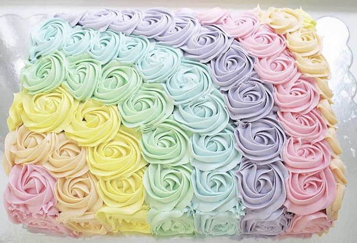 there is a cake that has been decorated with pastel colors