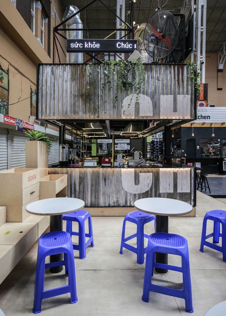 several blue and white stools sitting in front of tables