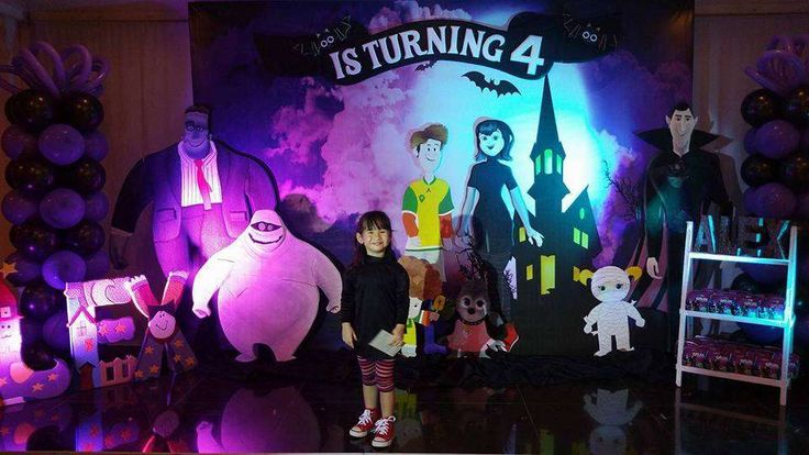 children standing in front of an animation backdrop with characters from the animated tv show's it's turning 4