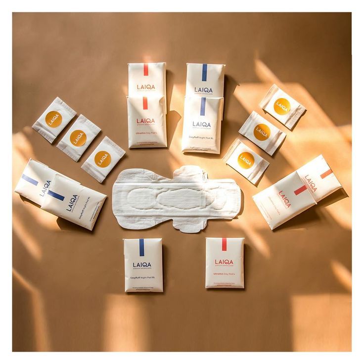 an assortment of personal care products laid out on a table with shadows from the sun