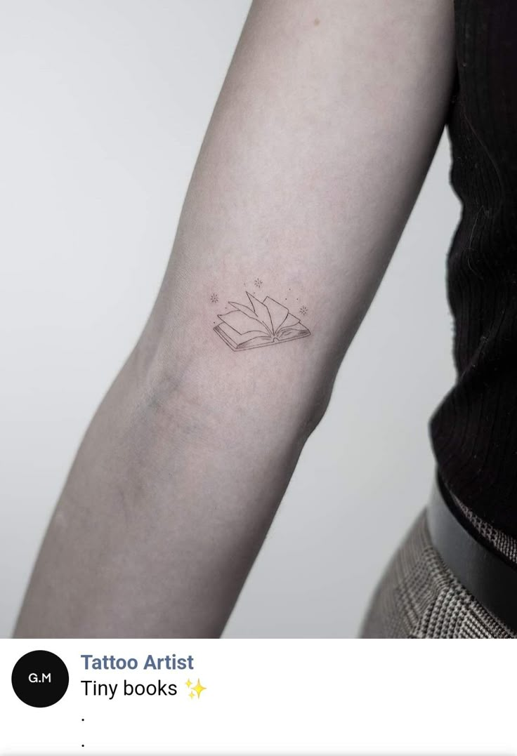 a woman's arm with a tattoo on it and the words tattoos artist tiny books