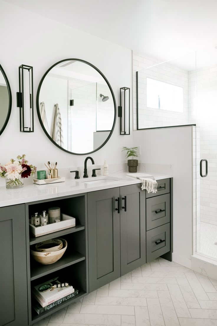 a bathroom with two round mirrors on the wall