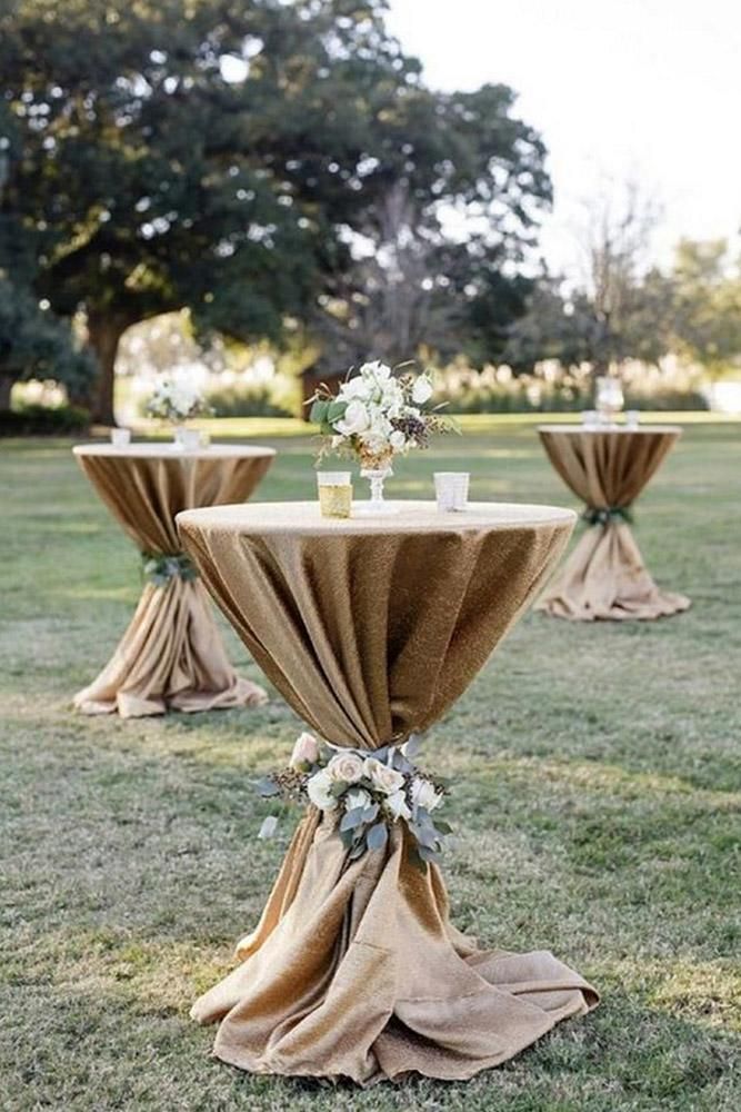 the table is covered with burlocks and draped linens for an elegant look