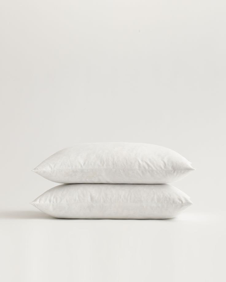 two white pillows stacked on top of each other