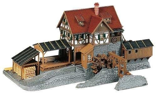 a wooden model of a house with a water wheel and steps leading up to it