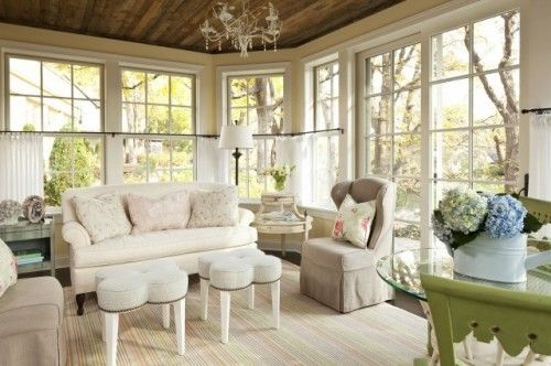 a living room filled with furniture and lots of windows