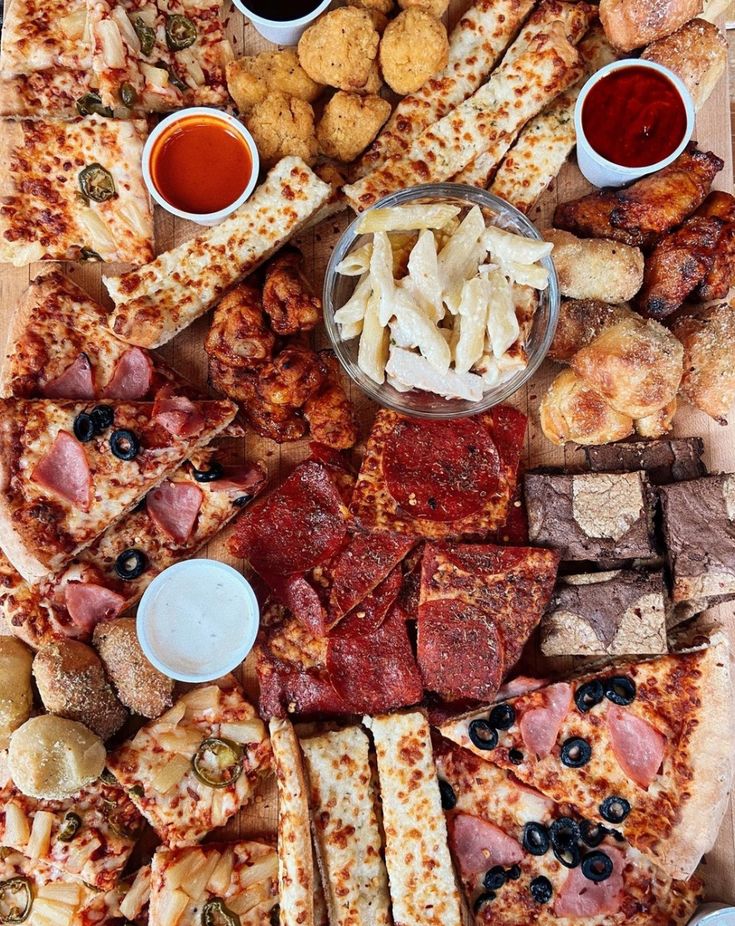 a pizza with many different toppings on it, including olives and other condiments