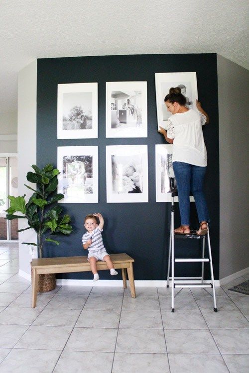 a woman standing on top of a ladder next to a child