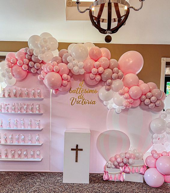 a pink and white balloon church with balloons on the front wall, an altar in the back