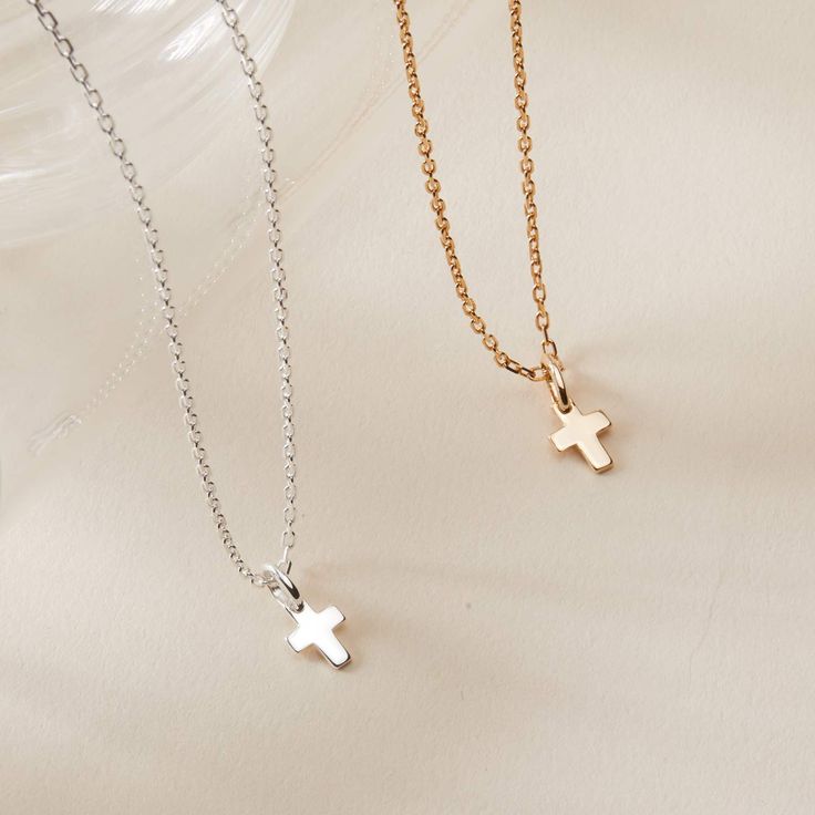 A timeless classic to treasure each day, our Mini Cross Charm Necklace is perfect for commemorating those special moments. Gift to a loved one or cherish your new favorite necklace in either 18K Champagne Gold Plated or 925 Sterling Silver.&nbsp;18K Champagne Gold Plated or 925 Sterling SilverMini Cross: 0.3 x 0.2Charms are removable from this chain and can be worn on all Merci Maman chain lengthsSent with love in a complimentary gift box Classic Cross Clavicle Chain Necklace, Classic Rose Gold Charm Necklace With Clavicle Chain, Gold Minimalist Cross Pendant Jewelry, Classic White Gold Charm Necklaces For Anniversary, Classic Charm Necklace For Anniversary, Classic Clavicle Chain Necklace With Cross Pendant, Minimalist Cross Necklace Tarnish Resistant, Classic Cross Pendant Clavicle Necklace, Classic White Gold Charm Necklace For Anniversary