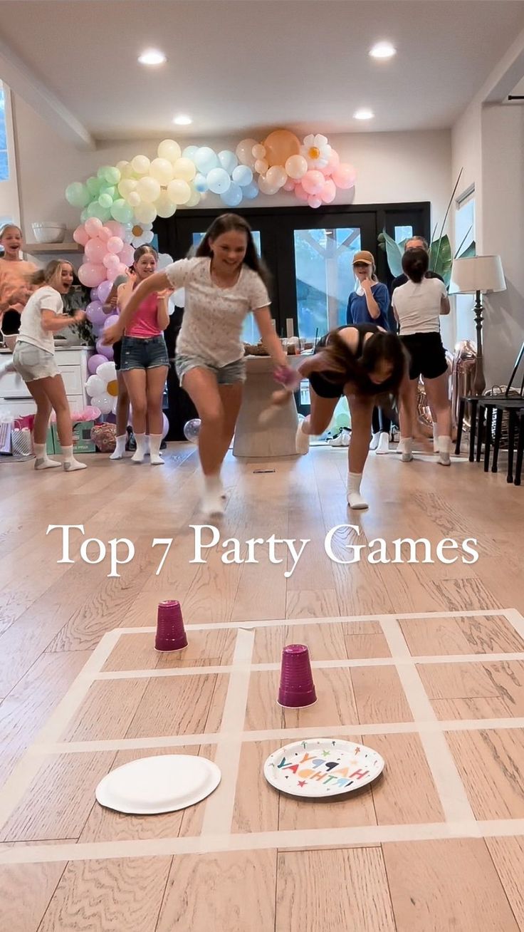 two women playing a game on the floor with balloons in the background and words top 7 party games