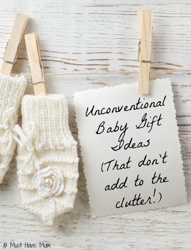 two baby mittens hanging on clothes pins with an inscription that reads, unconventional baby gift ideas that don't add to the clutter