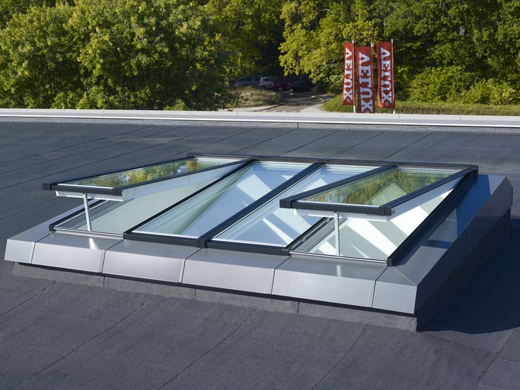 a roof with three glass windows on it