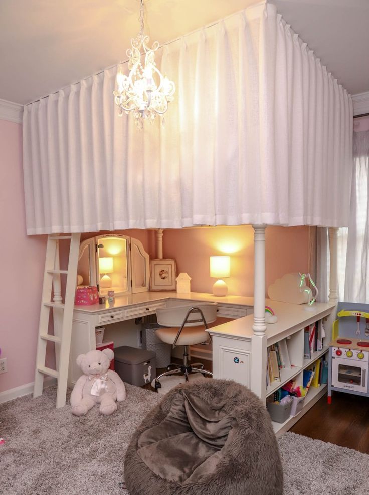 a loft bed with a desk and chair underneath it in a child's bedroom