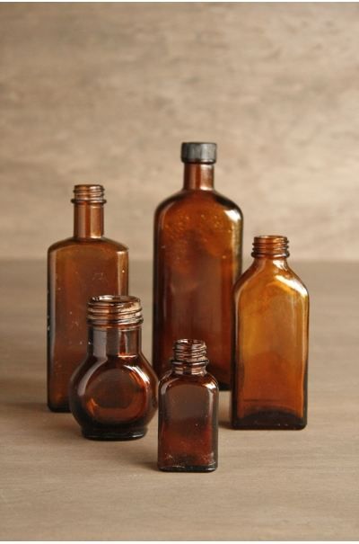 several brown glass bottles sitting next to each other