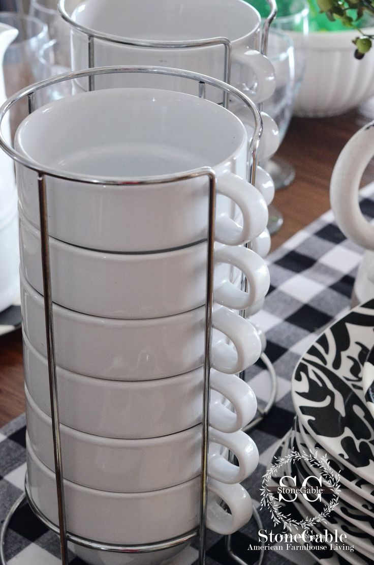 a stack of white cups sitting on top of a table