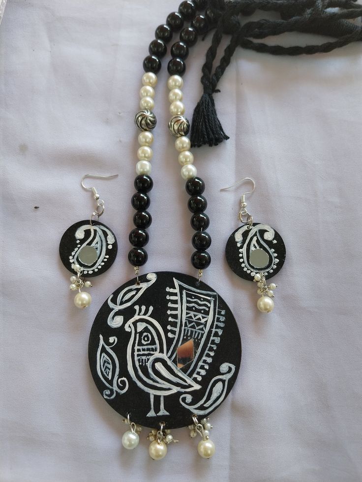 a necklace and earring set with black beads