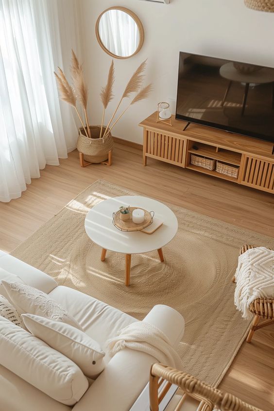 a living room filled with furniture and a flat screen tv on top of a wooden stand