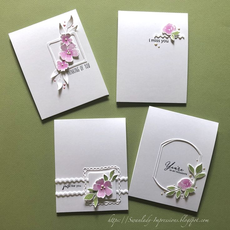 four cards with flowers on them sitting next to each other in front of a green background