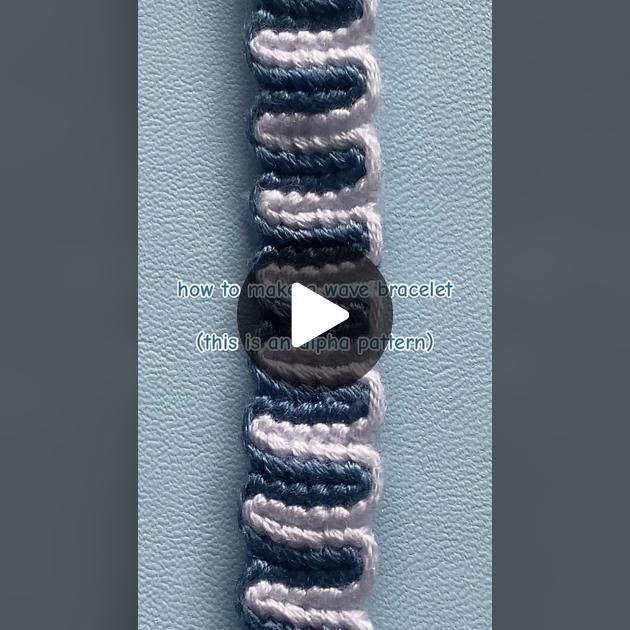 the video is showing how to make a bracelet with two different colored threads on it