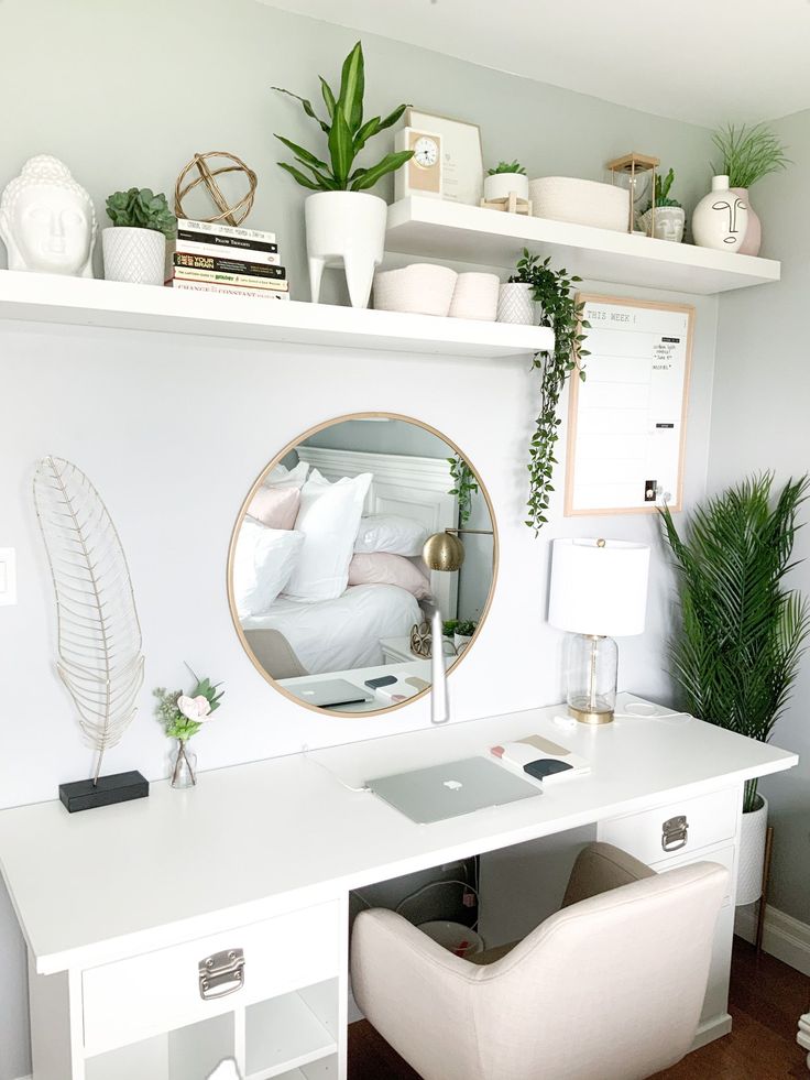 a white desk with a mirror and some plants