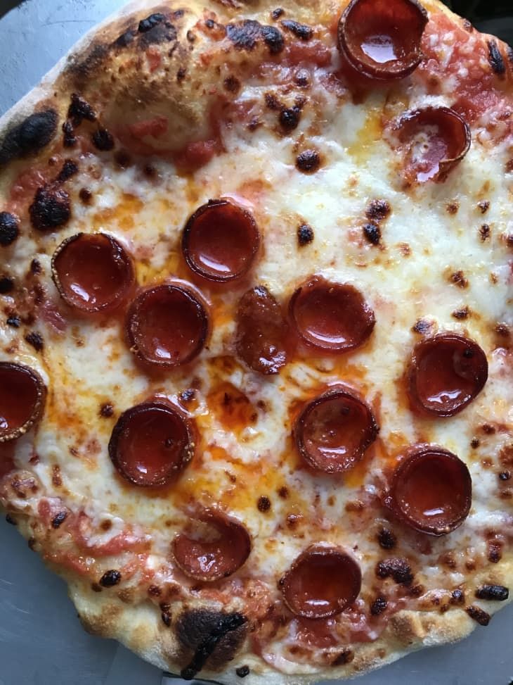 a pepperoni pizza sitting on top of a white plate