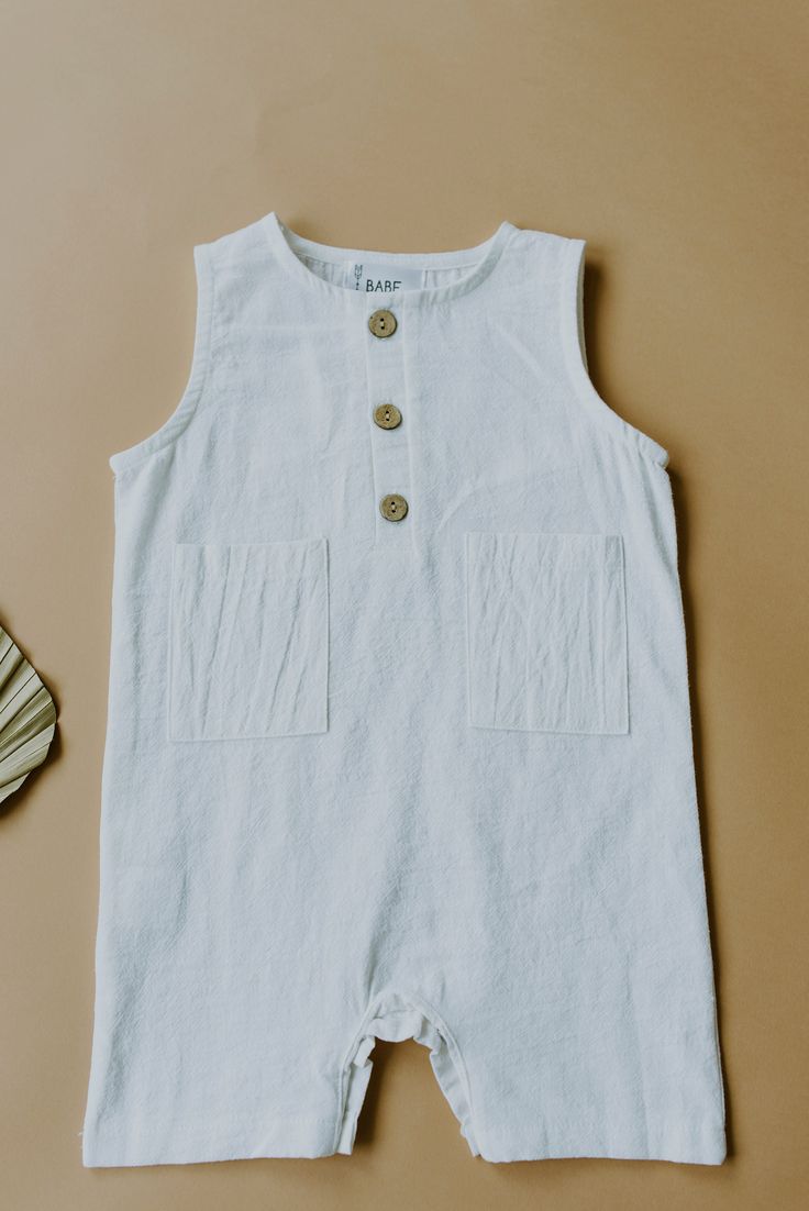 Our White Sleeveless Crop Linen Baby Romper is the cutest, light weight piece for warmer months! Bottom snaps and functioning buttons on front. Made with Linen. Cream Sleeveless Cotton Bubble Romper, White Cotton Playful Bubble Romper, White Playful Short Sleeve Bubble Romper, White Cotton Bubble Romper With Lace Trim, White Baby Romper, White Sleeveless, Baby Romper, Boy Fashion, Sleeveless Top