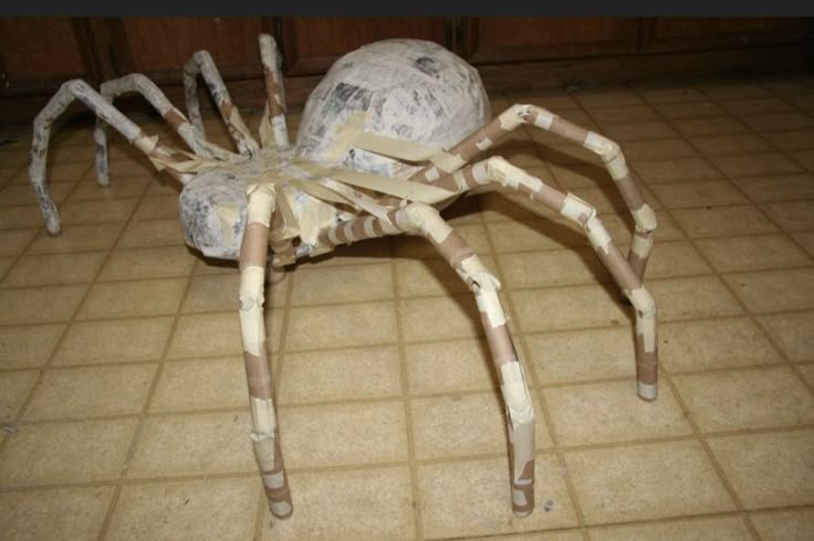 a spider made out of toilet paper on the floor