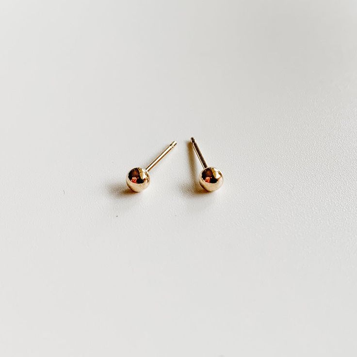 Our gold tiny stud earring pack is minimalist and chic!! Perfect for everyday wear and for multiple piercings. The set includes 4 mini geometric earring pairs; sphere, flat disc, heart and star shapes. Great for gifting - all of our jewelry comes in gift ready packaging. -- one pair gold filled tiny heart stud earrings (3.5mm) one pair gold filled star stud earrings (3.5mm) one pair gold filled sphere earrings (3 mm) one pair gold filled dot earrings (4mm) earring backs included: gold filled scr Simple Everyday Gold Piercings, Minimalist Nose Studs For Everyday Wear, Simple Gold Hypoallergenic Piercings, Minimalist 14k Gold Filled Piercings, Minimalist Round Nose Studs, Tiny Simple Gold Cartilage Earrings, Trendy Tiny Gold Cartilage Earrings, Minimalist Gold Cartilage Earrings, Minimalist 14k Gold Nickel-free Piercings