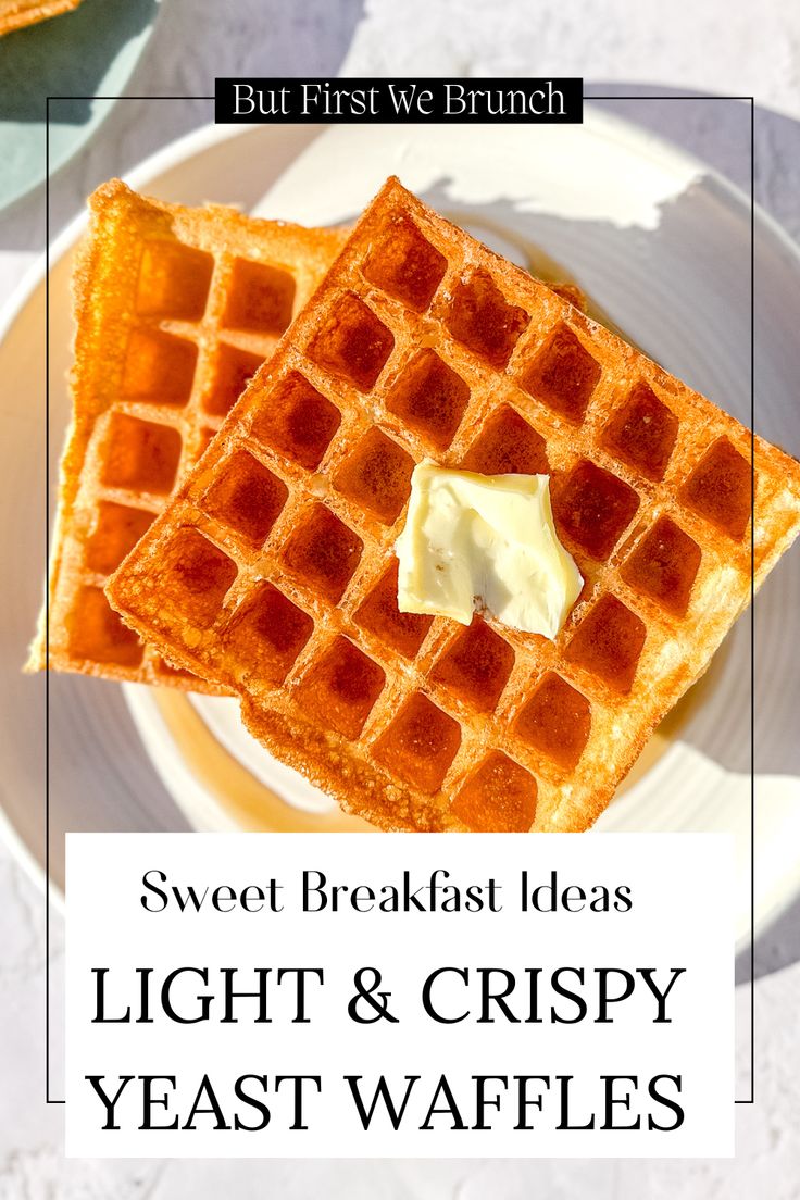 two waffles sitting on top of a white plate next to butter and syrup