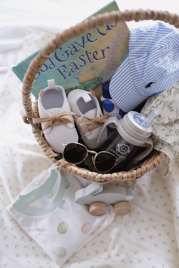 a basket filled with baby items sitting on top of a bed