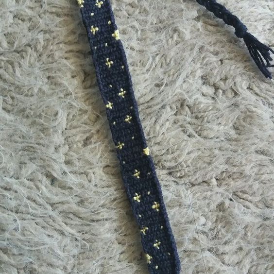 a crocheted tie with yellow stars on it