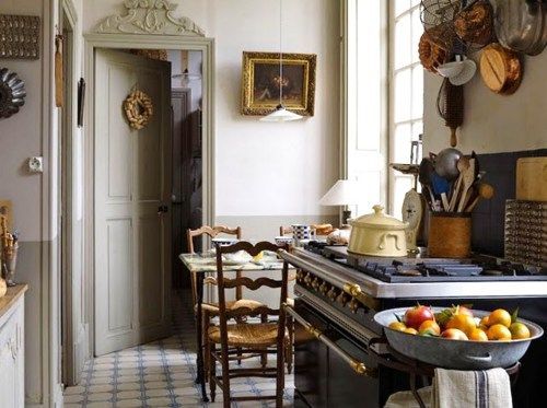 a kitchen with an old stove and fruit bowl on the counter in front of it