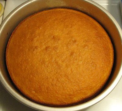 a cake in a pan sitting on top of a stove