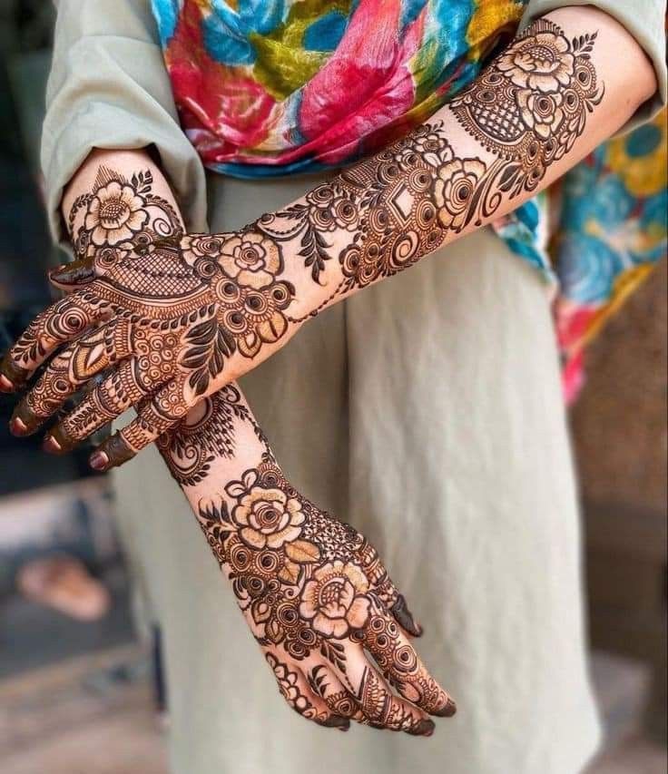 a woman's hands with hennap on it, showing the intricate design