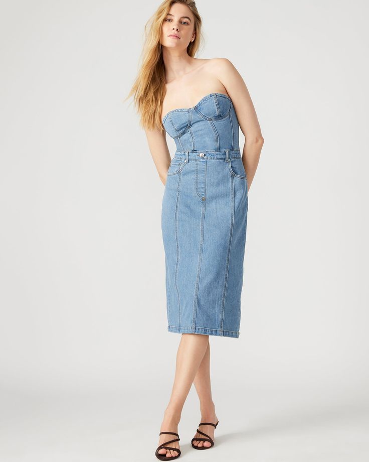 This denim dress combines the casual appeal of blue denim with the sophistication of a bustier top and pencil skirt. Perfect for a cocktail event or dinner out, the midi length offers just the right amount of coverage while still showing off your curves. Bustier denim midi dress Pencil skirt bottom Back zipper closure Length: 35.75" 98% cotton 2% spandex Hand wash Emma is 5ft 10in and is wearing a size small Imported Chic Fitted Midi-length Denim Dress, Fitted Medium Wash Midi Dress, Knee-length, Medium Wash Fitted Knee-length Midi Dress, Chic Bodycon Midi Corset Dress, Fitted Midi Denim Dress In Denim Blue, Fitted Midi-length Denim Dress For Spring, Fitted Midi Length Denim Dress, Fitted Midi Denim Dress For Spring, Fitted Denim Blue Midi Denim Dress