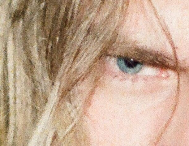 a close up of a person's face with long blonde hair and blue eyes