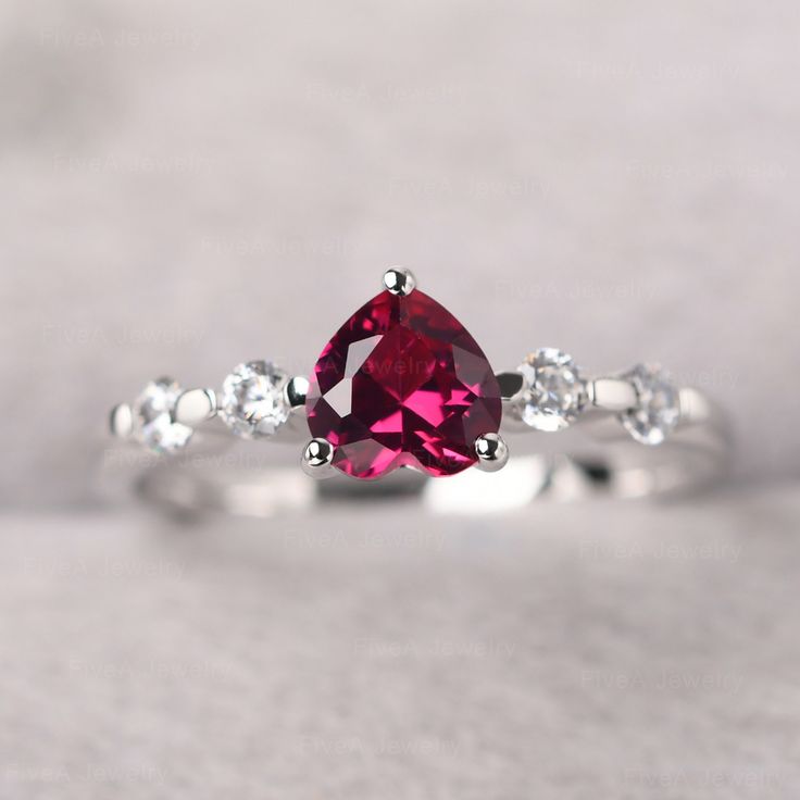 ◆ The ring is handcrafted from sterling silver and decorated with a dazzling 6*6 mm lab ruby and tiny CZs. It is suitable for engagement/anniversary/daily occasion. ◆ Production Description: Main stone Type: Lab ruby Main Stone Shape: Heart cut Main Stone Size: 6*6 mm(1.13 ct) Side stone: CZ Metal: 925 Sterling silver - Other options available in the drop down menu ◆ Customization: √Free for Add Engraving √Other Metal Type Available √Other Gemstones & Shapes Available √Personalization Reques Lab-created Ruby Birthstone Diamond Promise Ring, Lab-created Ruby Birthstone Diamond Ring For Promise, Lab-created Ruby Diamond Promise Ring With Birthstone, Lab-created Ruby Birthstone Ring In Fine Jewelry Style, Ruby Ring With Accent Stones For Promise, Ruby Birthstone Ring With Accent Stones For Promise, Lab-created Ruby Birthstone Promise Ring, White Ruby Gemstone Ring For Anniversary, Red Lab-created Ruby Birthstone Ring For Promise