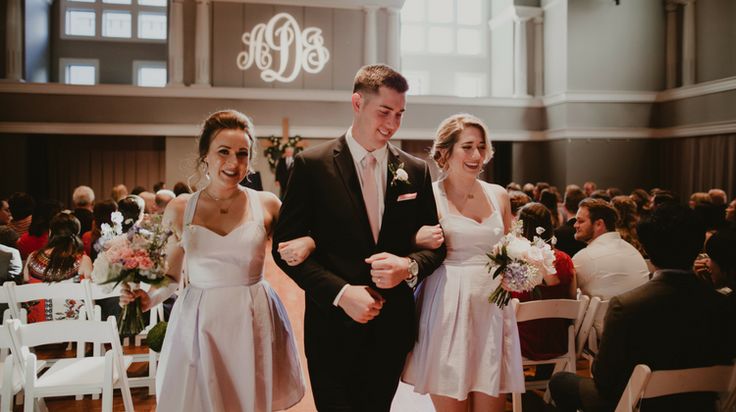 a bride and groom walking down the aisle